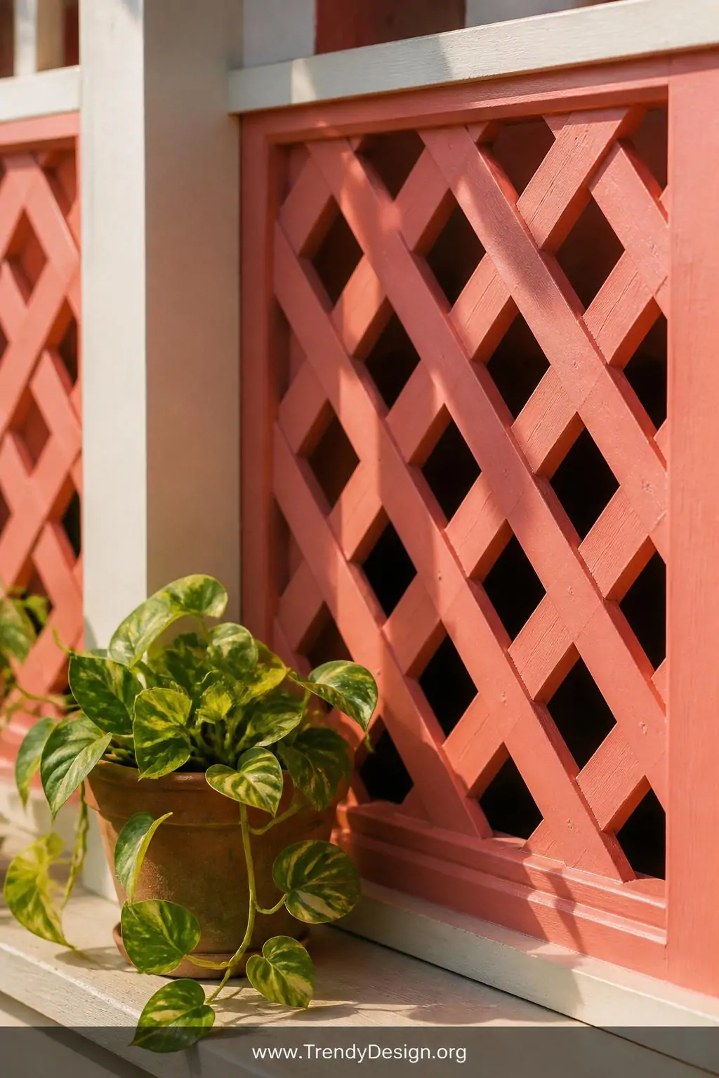 Closeup photorealistic shot of freshly painted deep coral pink lattice panels against cream painted porch trim, thick brushst