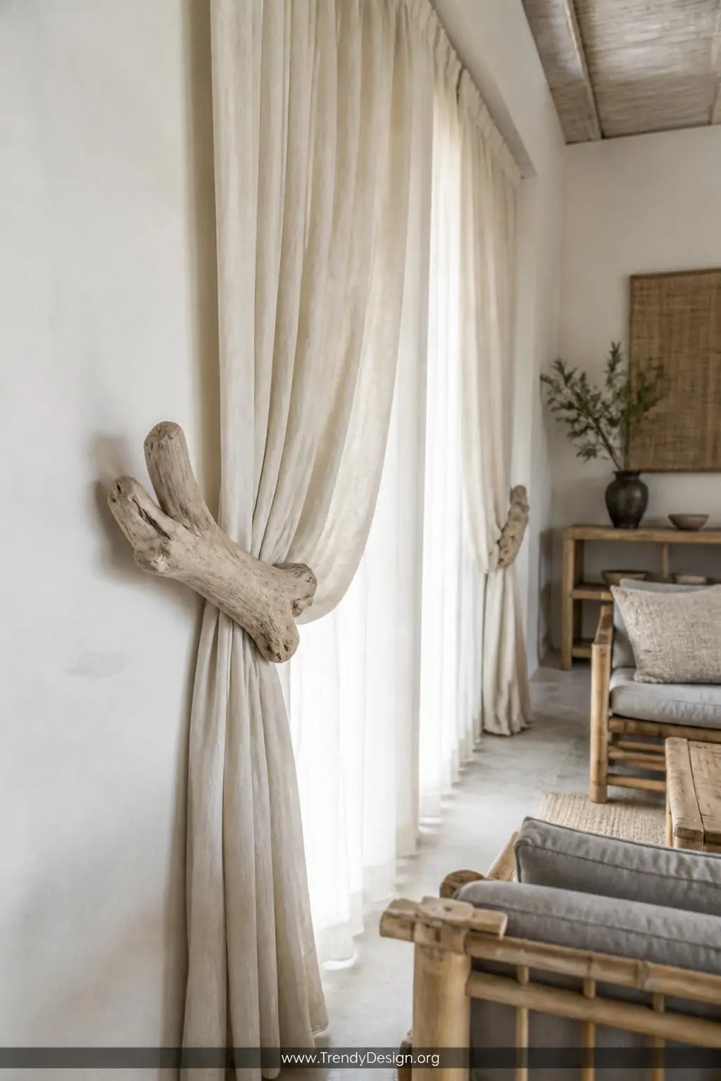 Wide photorealistic interior of a serene Japandi-inspired living room where smooth pale driftwood pieces mounted on whitewash