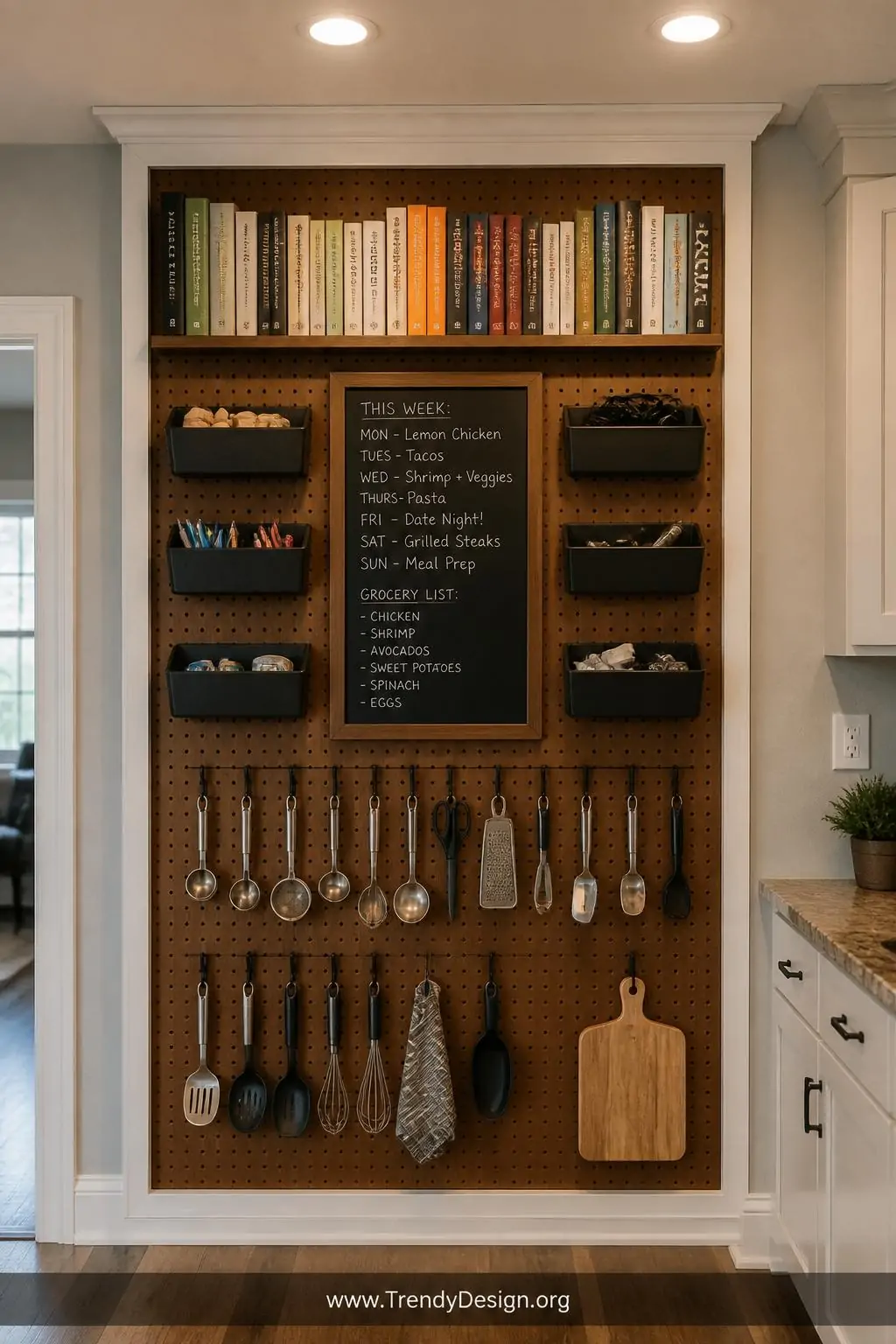 Floor-to-ceiling command center pegboard combining warm walnut wooden shelves stacked with cookbooks at the top, rows of matte black metal bins holding small tools mid-board, S-hooks loaded with daily utensils below, and a centered chalkboard panel insert with handwritten meal planning notes, framed with white painted trim for a built-in look, wide shot under warm recessed lighting against a soft greige kitchen wall.