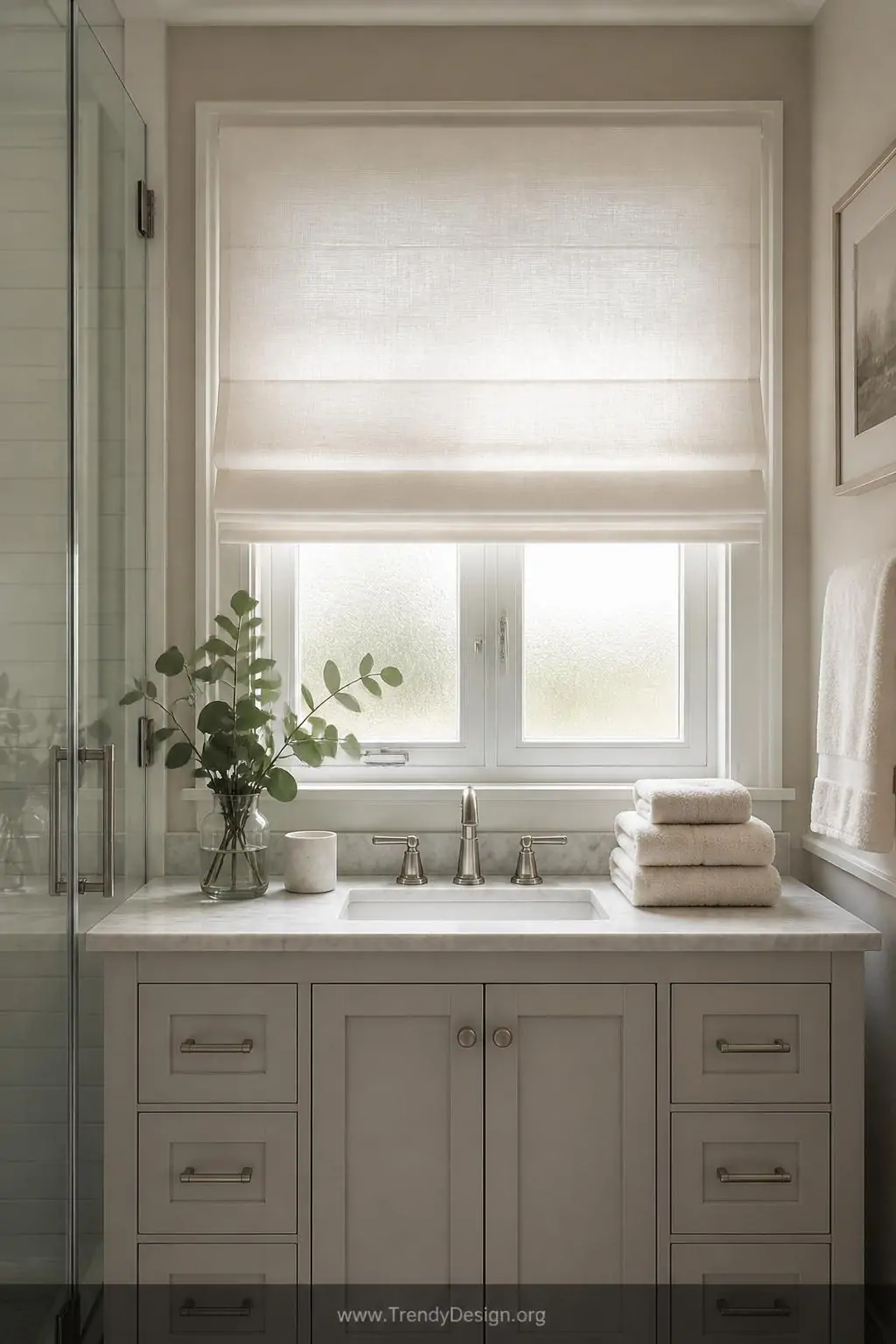 A compact but beautifully appointed bathroom with a moisture-resistant faux-silk Roman blind in soft warm white pulled three-