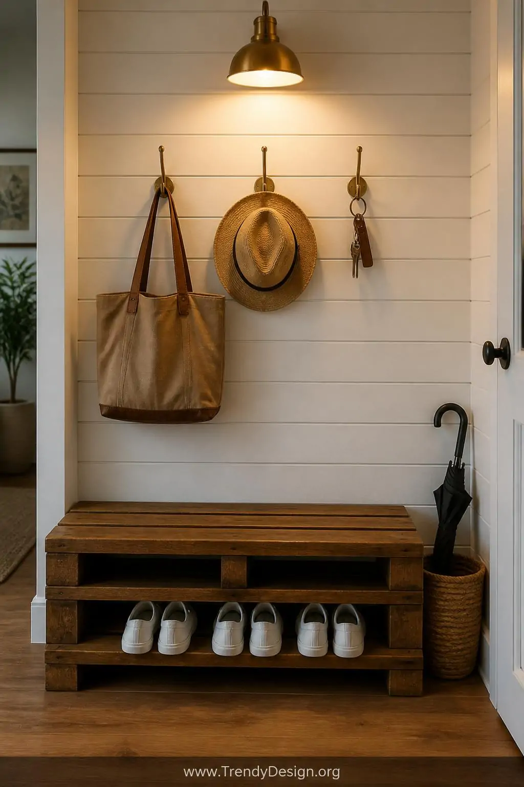 Medium shot of a welcoming home entryway featuring a single flat wood pallet bench stained a rich walnut brown with a smooth 