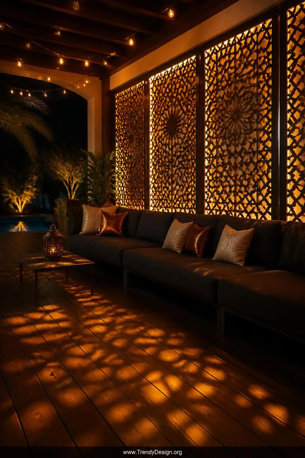 Wide photorealistic evening shot of intricate Moroccan-inspired laser-cut PVC lattice panels glowing with warm amber LED stri