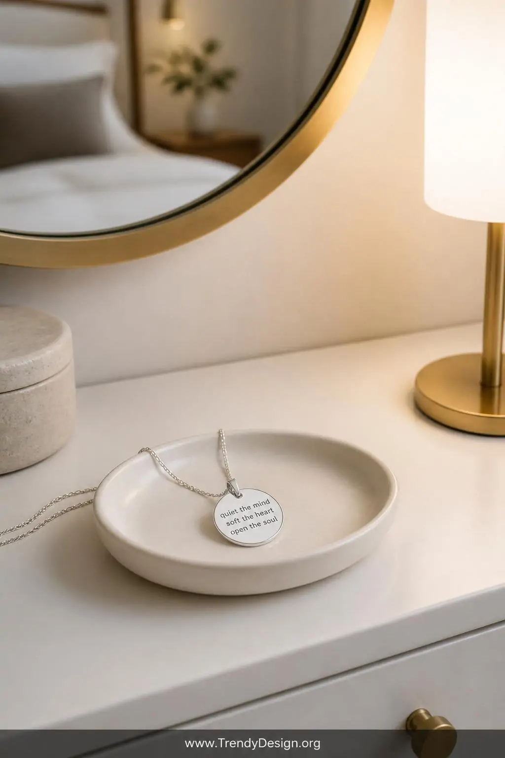 A closeup, photorealistic shot of a minimalist bedroom vanity in matte white with a round brushed gold mirror overhead and so