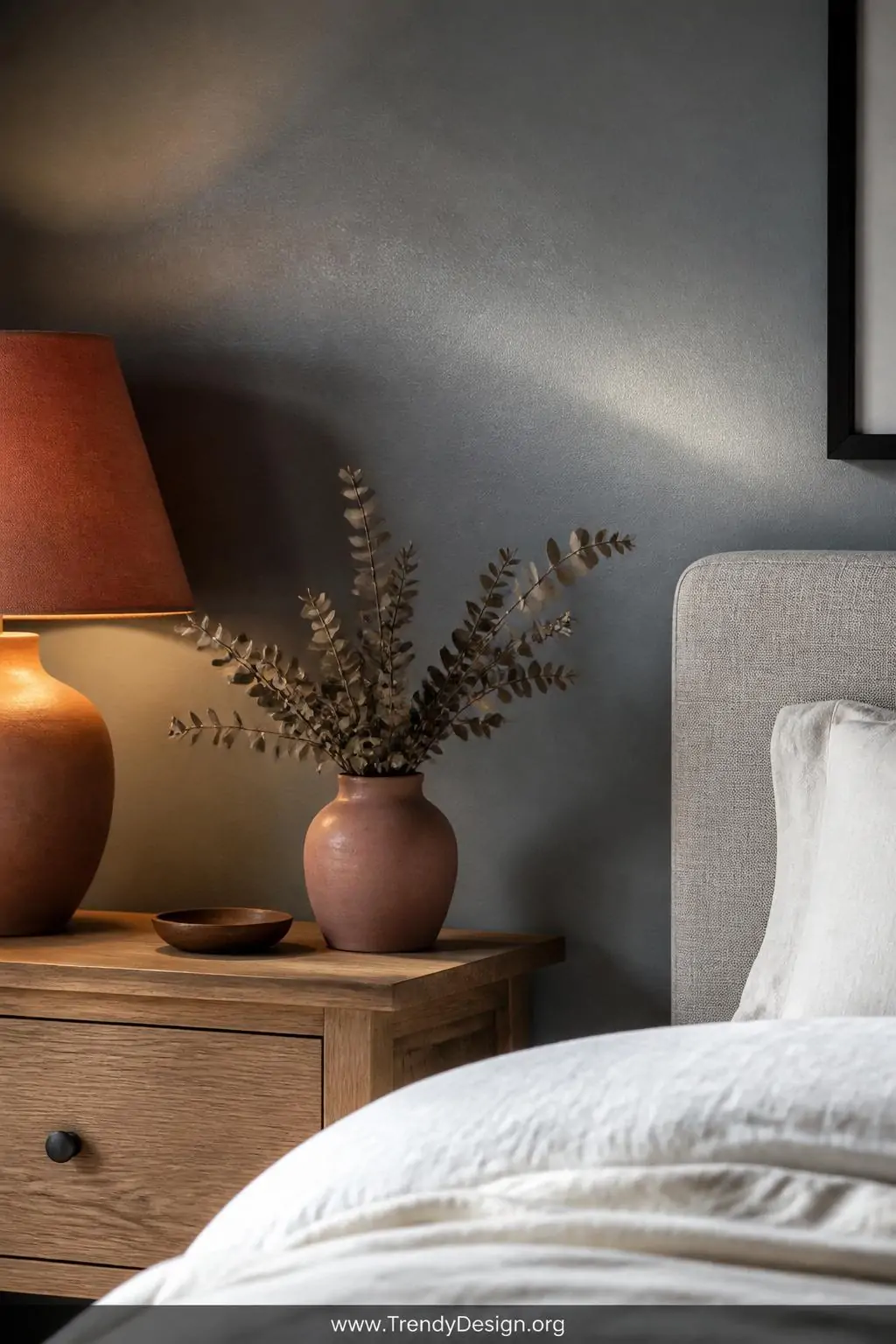 Closeup shot of a romantic bedroom wall in Farrow and Ball Mizzle slate blue-gray with a subtle eggshell sheen catching soft 