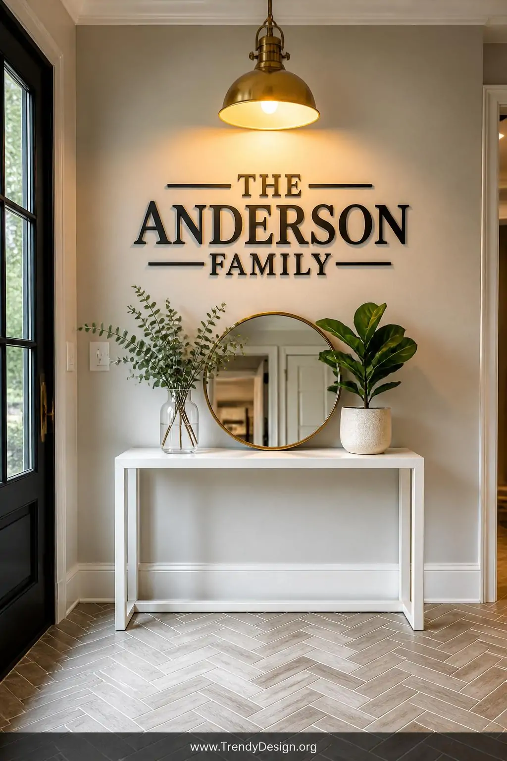 Wide shot of a polished entryway featuring a large elegant dark charcoal vinyl family name decal in a refined serif font moun